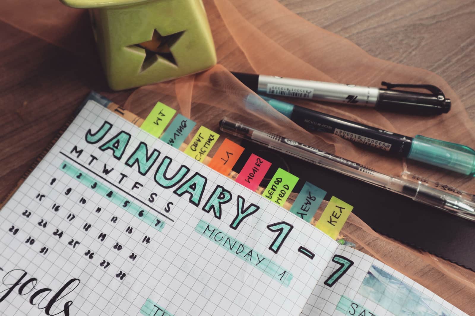 A calendar and notebook on a bright kitchen surface